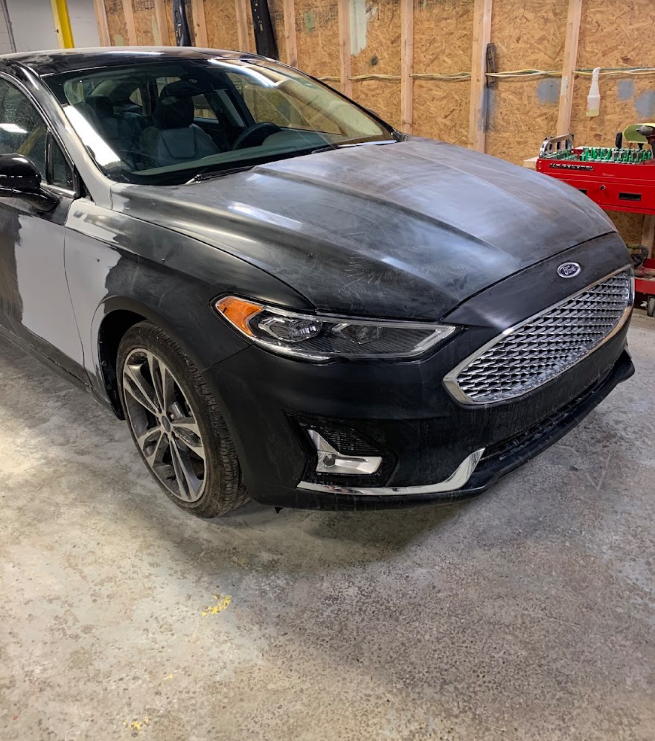 Ford sedan undergoing body repair work