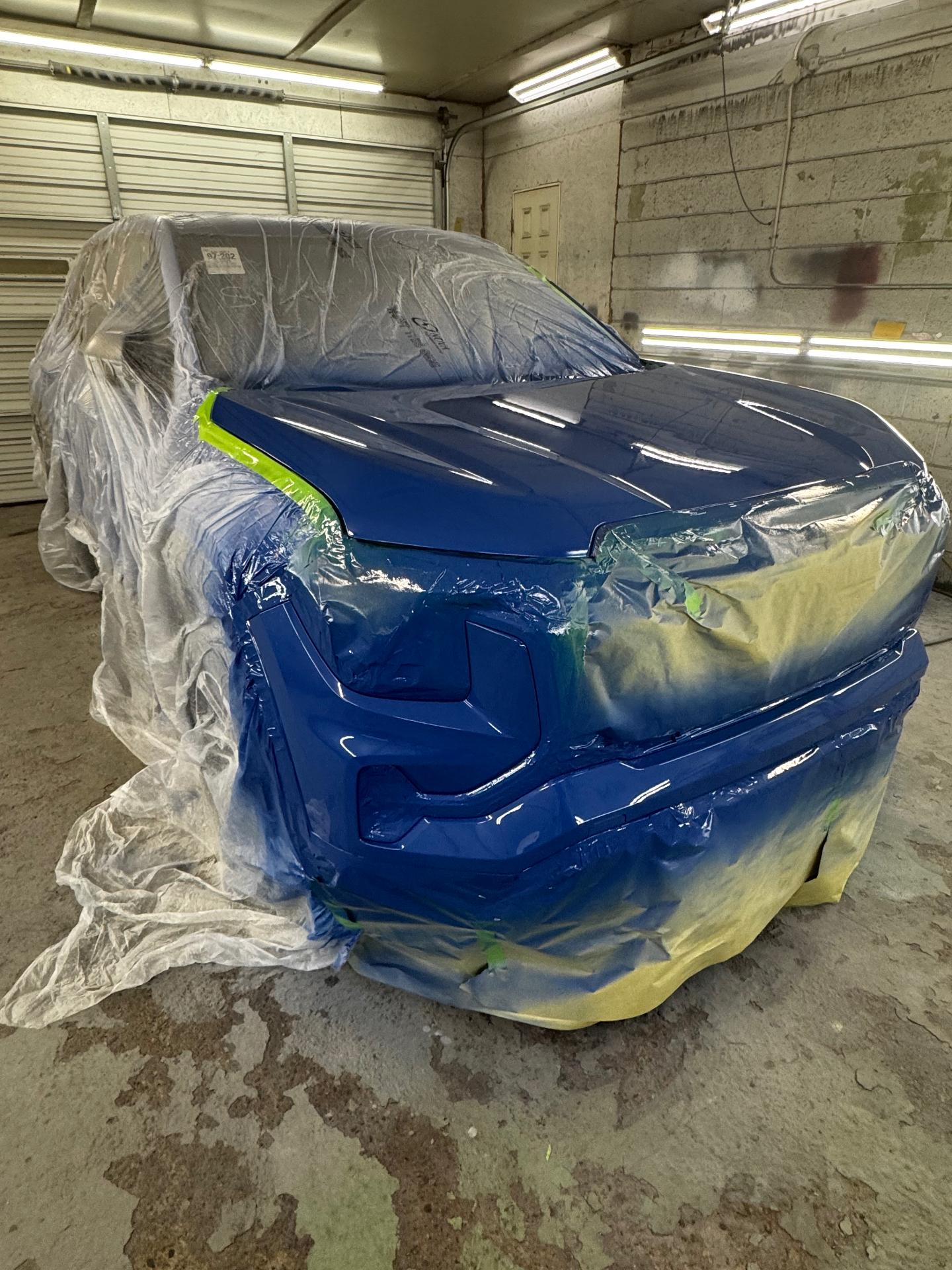 Blue Ford truck front end finished, after repair
