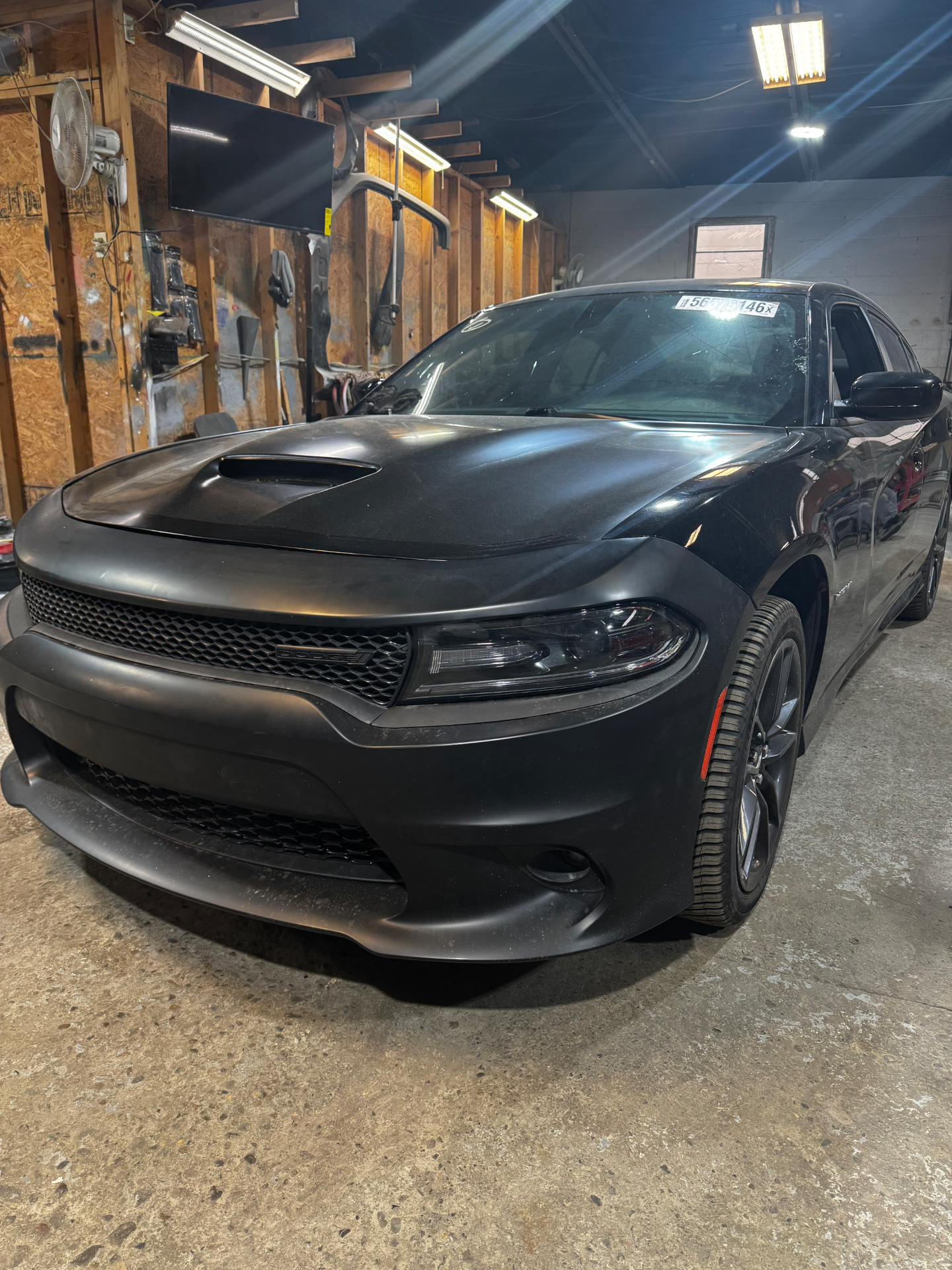 Black Dodge Charger with a fresh front end in the shop
